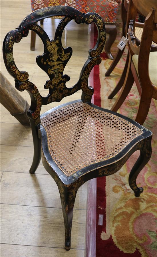 A Victorian part papier mache bedroom chair, decorated in gold with vases of flowers and scrolling foliage on a black